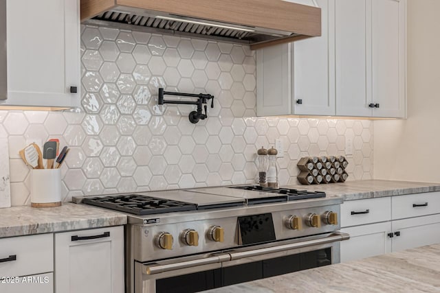 3814 W Running Deer Trl, Phoenix, AZ 85083 - kitchen featuring high end stainless steel range, extractor fan, decorative backsplash, and white cabinetry