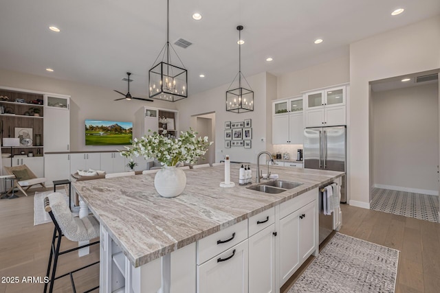 3814 W Running Deer Trl, Phoenix, AZ 85083 - kitchen with a chandelier, wood finished floors, light stone countertops, white cabinetry, and recessed lighting
