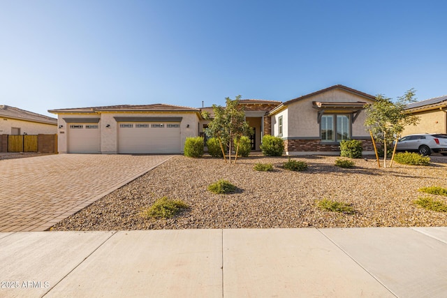 3814 W Running Deer Trl, Phoenix, AZ 85083 - view of front of property with decorative driveway, stucco siding, and an attached garage