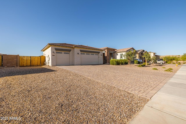 3814 W Running Deer Trl, Phoenix, AZ 85083 - view of front of property featuring stucco siding, decorative driveway, a garage, and a gate
