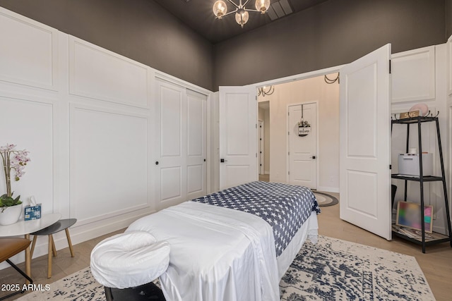 3814 W Running Deer Trl, Phoenix, AZ 85083 - bedroom featuring a chandelier, light wood-type flooring, and a closet