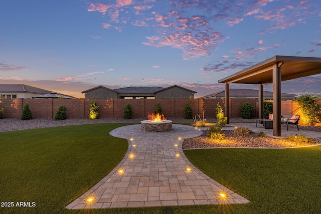 3814 W Running Deer Trl, Phoenix, AZ 85083 - yard at dusk with a fire pit, a patio, and a fenced backyard
