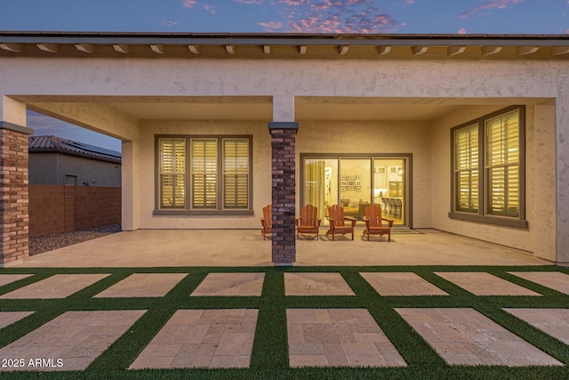3814 W Running Deer Trl, Phoenix, AZ 85083 - back of property at dusk with stucco siding and a patio