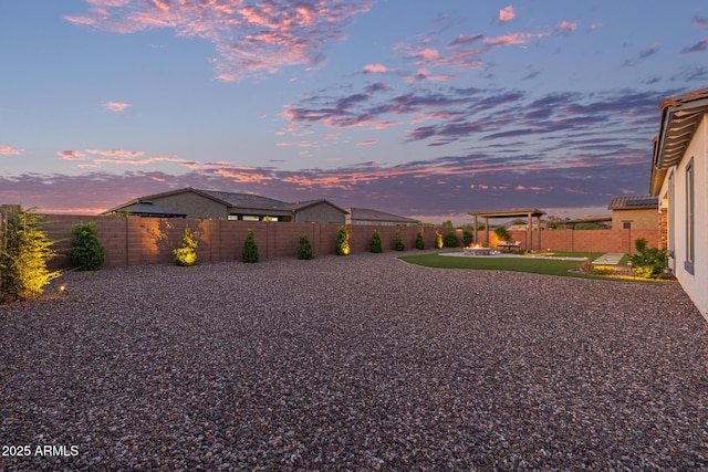 3814 W Running Deer Trl, Phoenix, AZ 85083 - yard at dusk with a fenced backyard, a pergola, and a patio