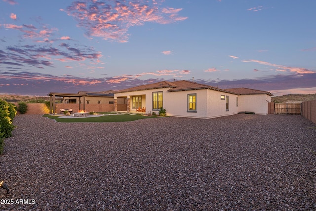 3814 W Running Deer Trl, Phoenix, AZ 85083 - back of property at dusk featuring a fenced backyard, a patio, and stucco siding
