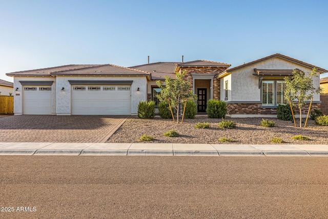 3814 W Running Deer Trl, Phoenix, AZ 85083 - view of front of house featuring driveway, stucco siding, an attached garage, a tile roof, and french doors