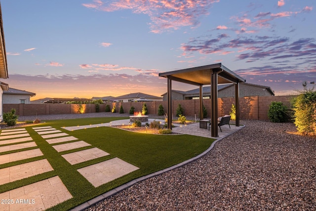 3814 W Running Deer Trl, Phoenix, AZ 85083 - yard at dusk with a patio area and a fenced backyard