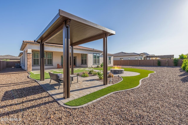 3814 W Running Deer Trl, Phoenix, AZ 85083 - rear view of house with a fenced backyard, a patio, an outdoor fire pit, and stucco siding