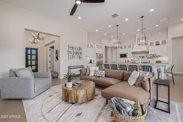 3814 W Running Deer Trl, Phoenix, AZ 85083 - living area with light wood-type flooring, a chandelier, ceiling fan, recessed lighting, and a high ceiling