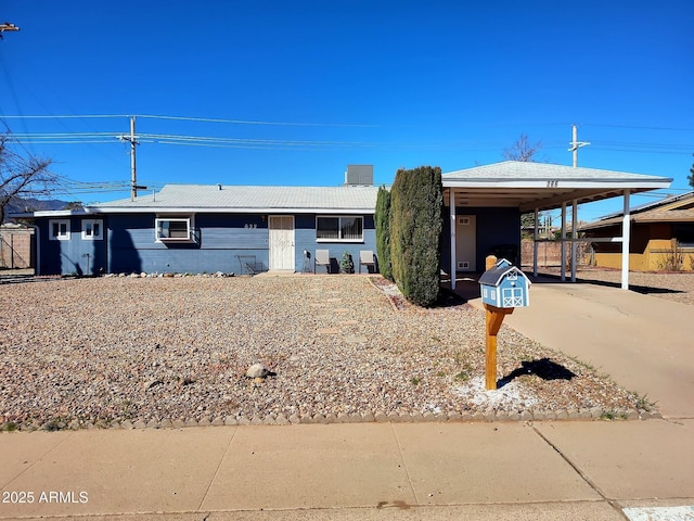 view of front facade with a carport and concrete driveway