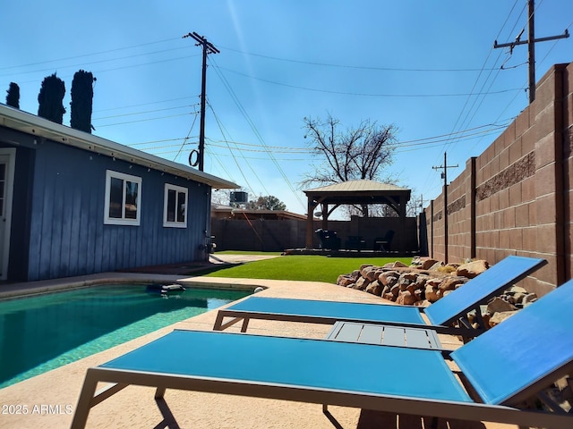 view of pool featuring a fenced backyard, a gazebo, a lawn, a fenced in pool, and a patio area