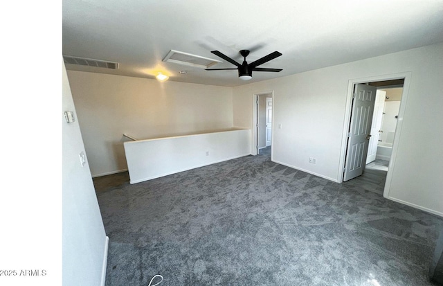 empty room featuring dark colored carpet, a ceiling fan, baseboards, and visible vents