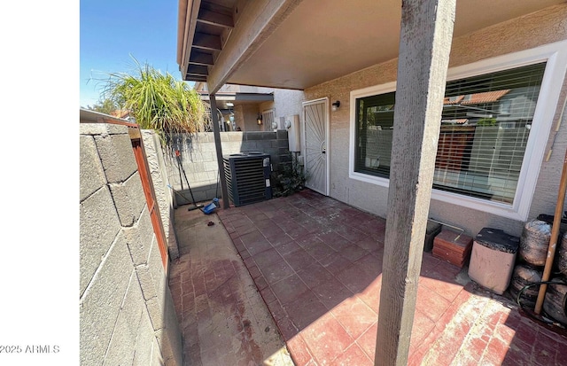 view of patio / terrace featuring fence and cooling unit
