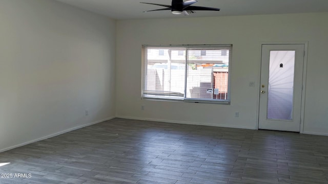interior space with baseboards, ceiling fan, and wood finished floors
