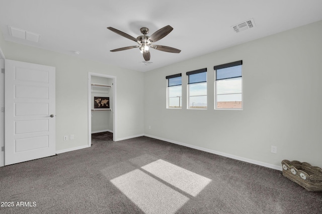 19026 W Becker Ln, Surprise, AZ 85388 - unfurnished bedroom featuring carpet, baseboards, a spacious closet, a ceiling fan, and a closet