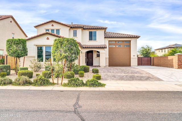 19026 W Becker Ln, Surprise, AZ 85388 - mediterranean / spanish-style house featuring driveway, stucco siding, fence, a tiled roof, and an attached garage
