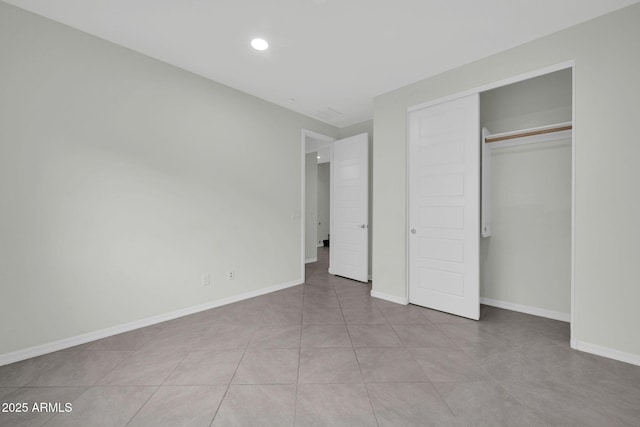 19026 W Becker Ln, Surprise, AZ 85388 - unfurnished bedroom with baseboards, recessed lighting, a closet, and tile patterned flooring