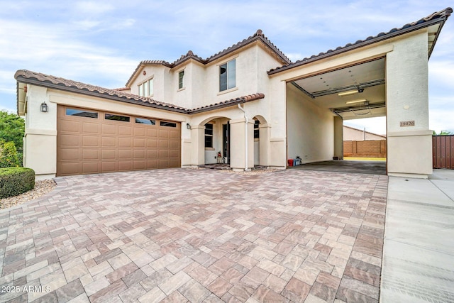 19026 W Becker Ln, Surprise, AZ 85388 - mediterranean / spanish-style house featuring a tile roof, fence, stucco siding, and decorative driveway