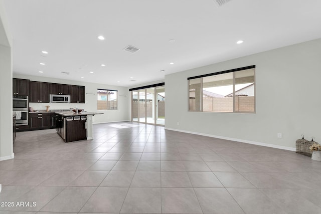 19026 W Becker Ln, Surprise, AZ 85388 - unfurnished living room with recessed lighting, light tile patterned floors, and baseboards