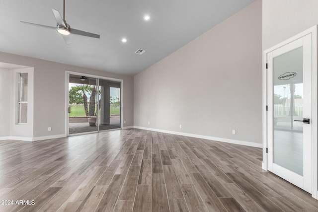 unfurnished living room featuring hardwood / wood-style floors, high vaulted ceiling, and ceiling fan