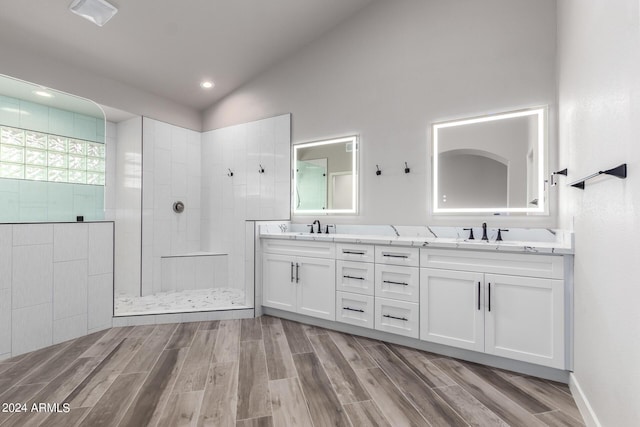 bathroom with vanity, lofted ceiling, and walk in shower