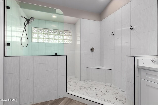 bathroom with vanity and tiled shower