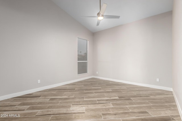 spare room with ceiling fan and lofted ceiling