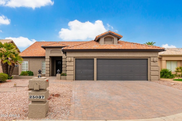 mediterranean / spanish home with a garage