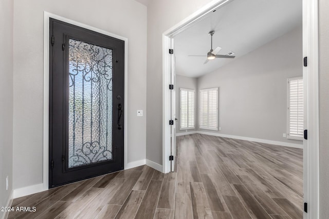 foyer featuring hardwood / wood-style floors, ceiling fan, and vaulted ceiling