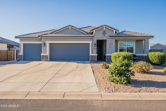 9454 E Alfalfa Dr, Florence, AZ 85132 - view of front facade with stone siding, a garage, stucco siding, driveway, and a tile roof