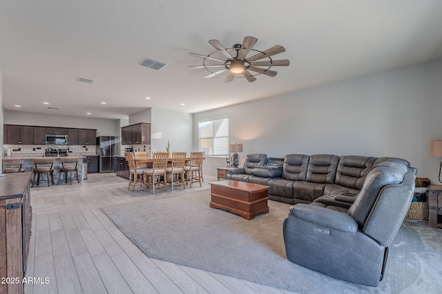9454 E Alfalfa Dr, Florence, AZ 85132 - living room with a ceiling fan, light wood-style floors, and recessed lighting