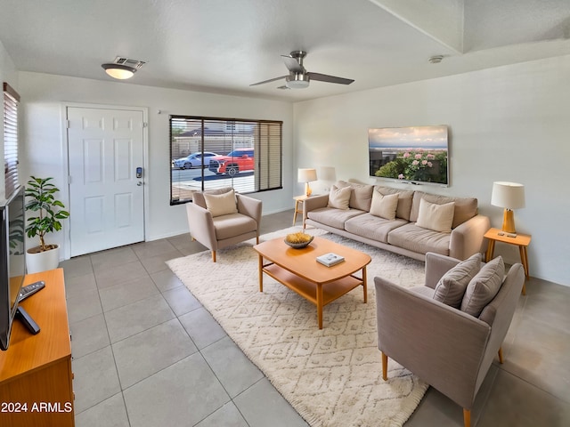 tiled living room with ceiling fan