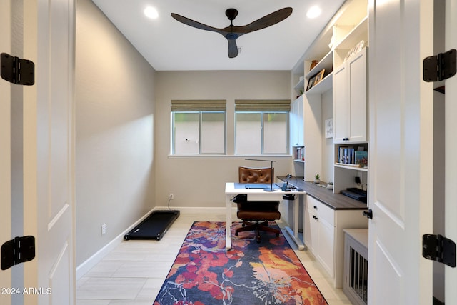 office with ceiling fan, built in desk, and light wood-type flooring