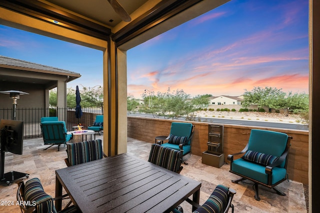 patio terrace at dusk featuring an outdoor living space