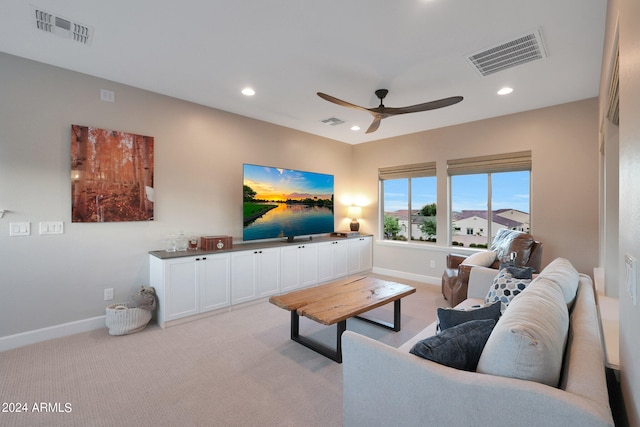 carpeted living room featuring ceiling fan