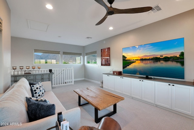 living room with ceiling fan and light colored carpet