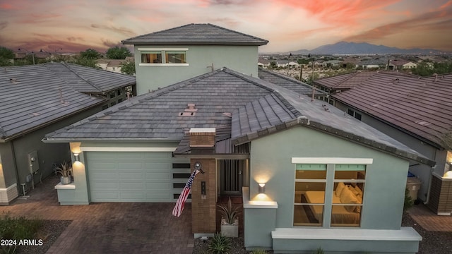 view of front of property with a garage and a mountain view