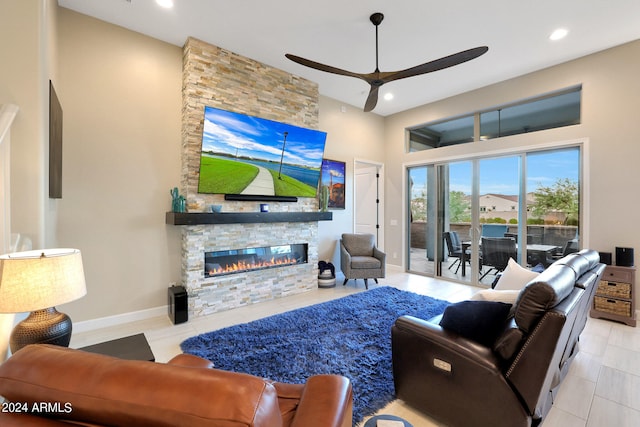 living room with ceiling fan, light tile patterned floors, and a fireplace