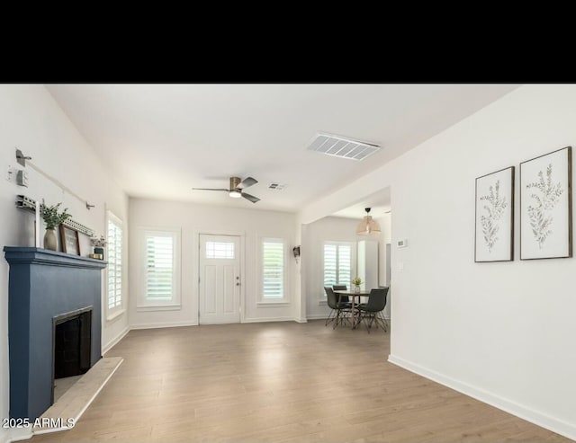 foyer featuring ceiling fan and light wood-type flooring