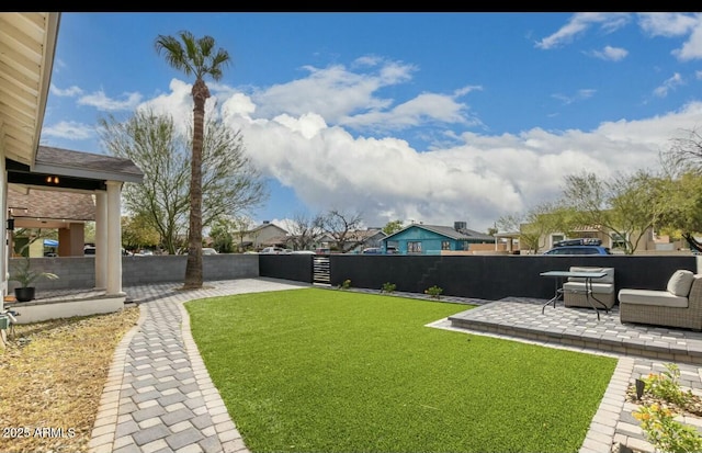 view of yard featuring an outdoor living space and a patio area