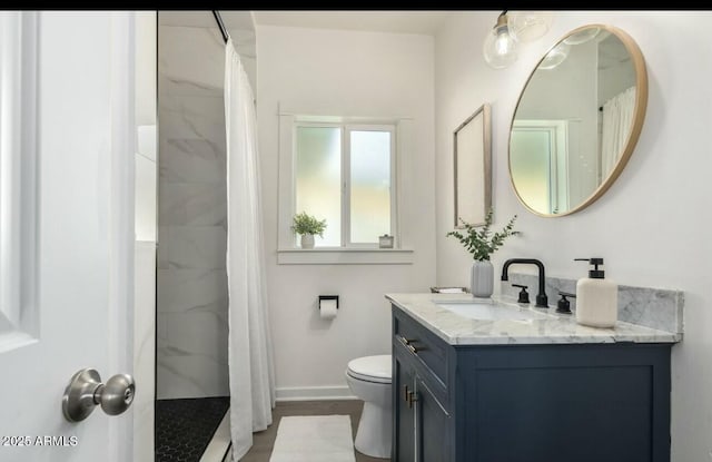 bathroom featuring vanity, toilet, and walk in shower