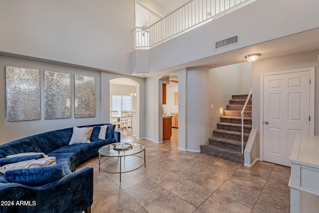 living room featuring a high ceiling and light tile patterned flooring