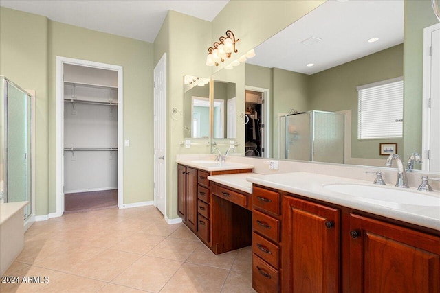 bathroom with vanity, a shower with door, and tile patterned flooring