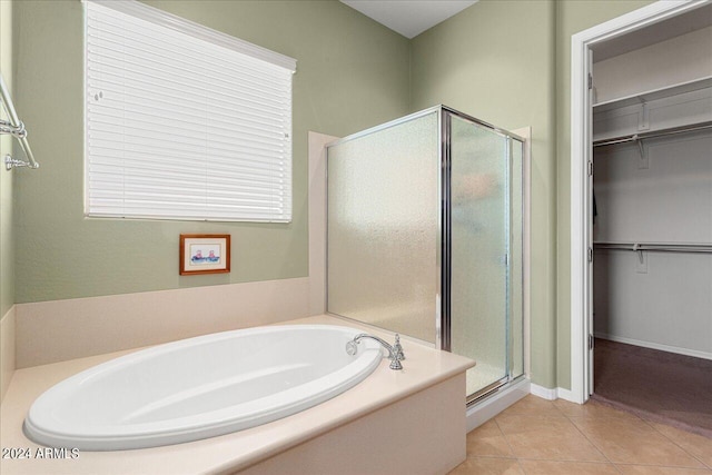 bathroom with independent shower and bath and tile patterned flooring