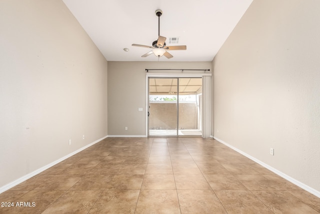 tiled empty room featuring ceiling fan