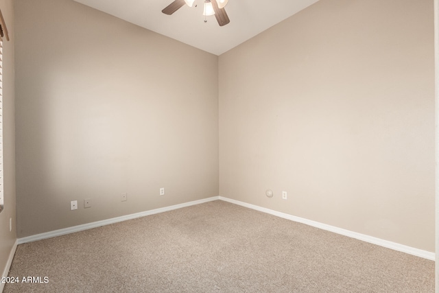 carpeted empty room featuring ceiling fan and lofted ceiling