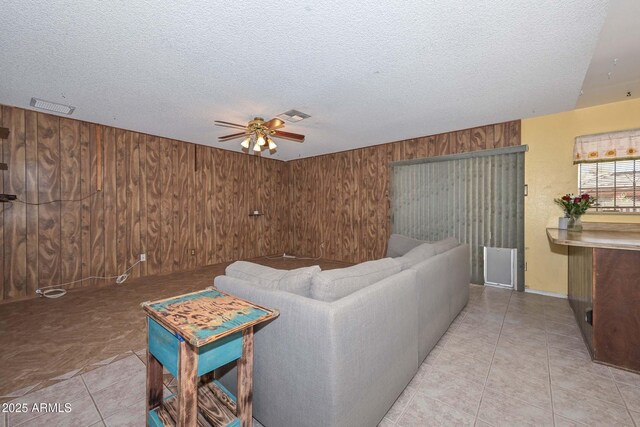 18012 N 37th Dr, Glendale, AZ 85308 - living area with wood walls, ceiling fan, and visible vents