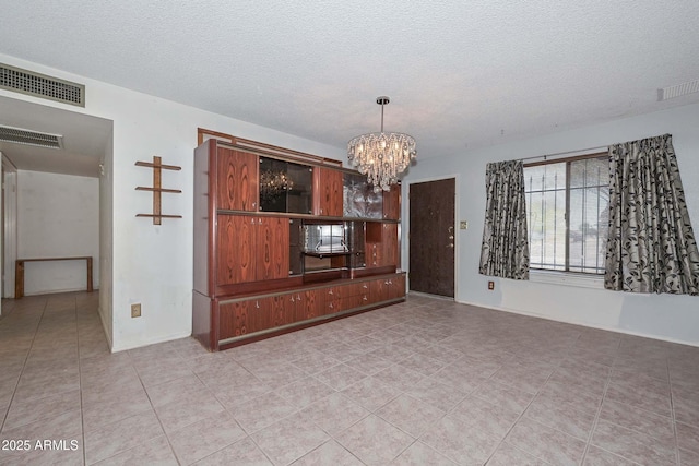 18012 N 37th Dr, Glendale, AZ 85308 - unfurnished room featuring visible vents, a textured ceiling, and an inviting chandelier