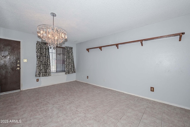 18012 N 37th Dr, Glendale, AZ 85308 - spare room featuring a textured ceiling, a notable chandelier, and baseboards