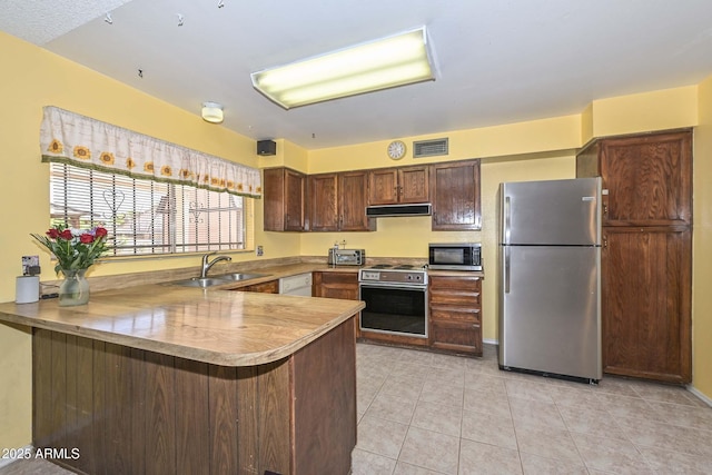 18012 N 37th Dr, Glendale, AZ 85308 - kitchen featuring light tile patterned floors, a sink, ventilation hood, appliances with stainless steel finishes, and a peninsula